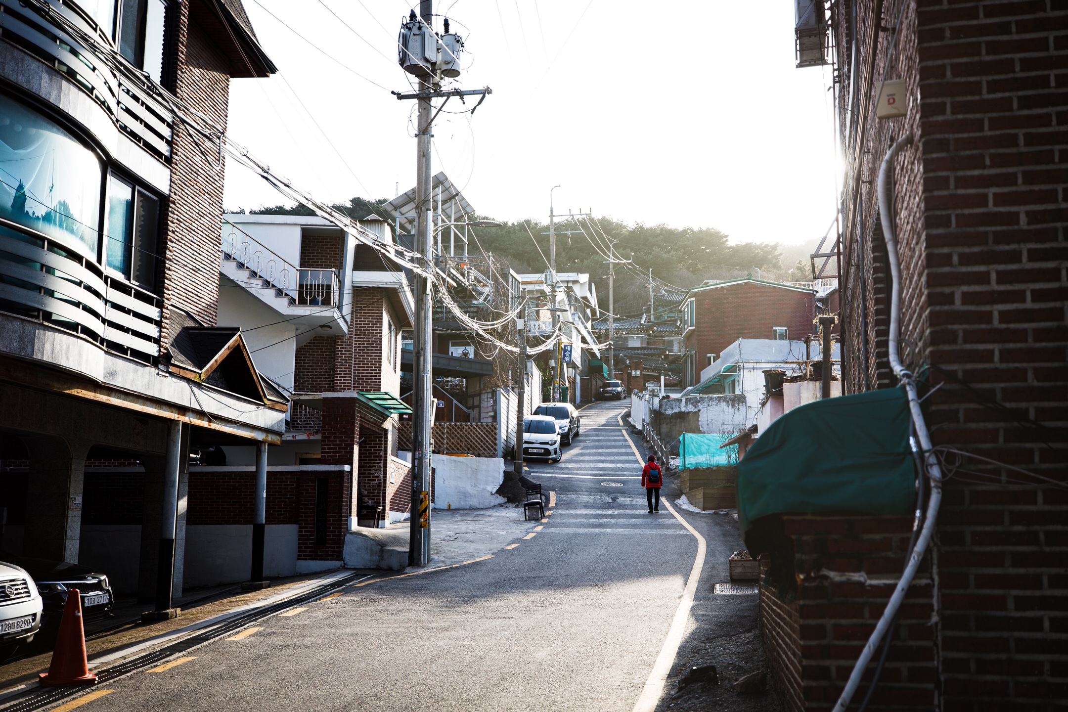 Uphill street with plenty of apparent wiring.